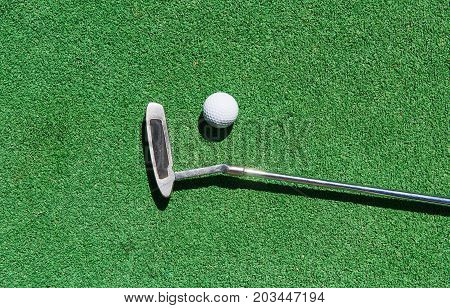 Mini-golf ball on artificial grass. Summer season game
