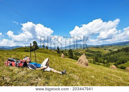 Hiking in the mountains with a backpack in the summer.