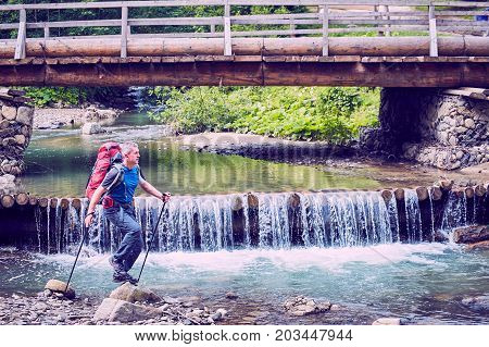 Hiking in the mountains with a backpack in the summer.
