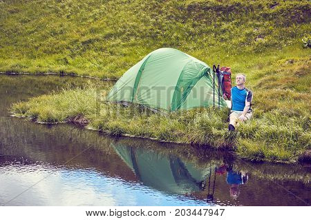 Hiking in the mountains with a backpack in the summer.