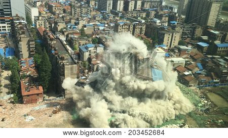 Downtown building demolition by controlled implosion in China