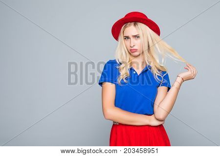 Portrait Of A Stunning Fashionable Lady Offended Girl In Bright Red Dress Posing Over Gray Backgroun