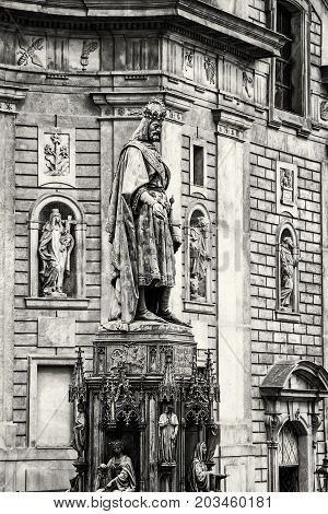 Old statue of Charles IV and St. Francis of Assissi church Prague Czech republic. Black and white photo.