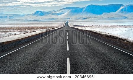 Highway route in Siberia to the snowy mountains