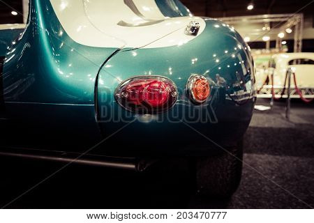MAASTRICHT NETHERLANDS - JANUARY 09 2015: Stop-lights of a sports racing car Jaguar D-Type 1956. Vintage toning. Stylization. International Exhibition InterClassics & Topmobiel 2015