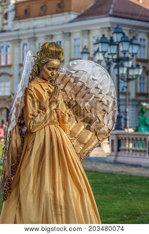 TIMISOARA ROMANIA - SEPTEMBER 8 2017: Living statue of a woman dressed with angel elements and present on the street inside the CheckART Carnival organized by the City Hall Timisoara. Union Square.