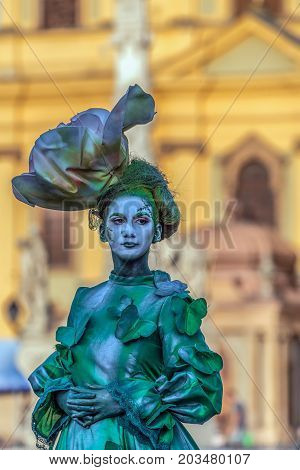 TIMISOARA ROMANIA - SEPTEMBER 8 2017: Living statue of a woman dressed with summer elements and present on the street inside the CheckART Carnival organized by the City Hall Timisoara. Union Square.