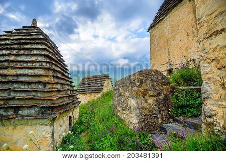 City of the dead or a necropolis near the village of Dargavs in Alania. Old cemetery with traditional crypts and tombs in the mountains