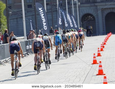 STOCKHOLM - AUG 26 2017: Rear view of a largegroup of female triathlete cyclists in the Women's ITU World Triathlon series event August 26 2017 in Stockholm Sweden