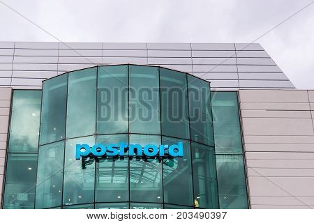 Glass and metal building with postnord sign and logo Amager Copenhagen Denmark September 8 2017