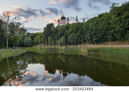 Domes of the monastery are reflected in the lake of Theophany Park. Kiev Ukraine