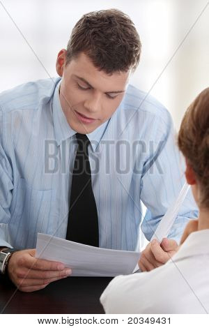 Business coaching concept. Young woman being interviewed for a job.
