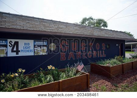 CREST HILL, ILLINOIS / UNITED STATES - JULY 20, 2017: One may drink beer and eat food at Gustos Bar and Grill, on Plainfield Road.