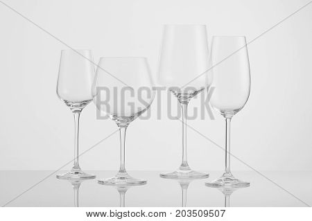 several empty wine glasses on a white background