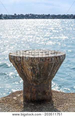 Dock Cleats On A Pier To Tie-up Boats With Blue Sea As The Background