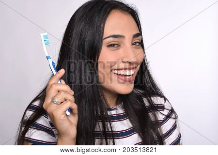 Close-up woman brushing her teeth. Isolated white background.