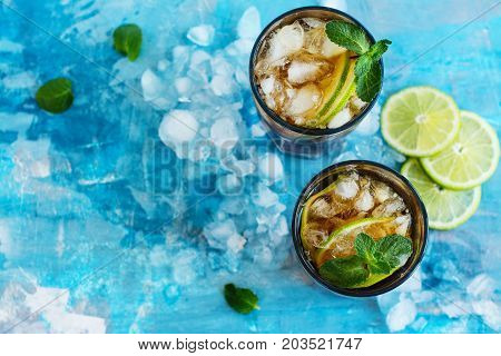 Summer cuba libre cocktail with lime and mint. Space for text