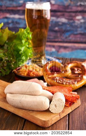 Vertical shot of Oktoberfest food, consisting of white sausages, pretzles and beer