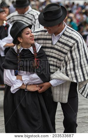 June 17 2017 Pujili Ecuador: indigenous man and woman dancing in traditional costumes at Corpus Christi parade