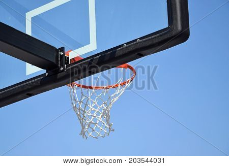 Basketball hoop against sky in summer time