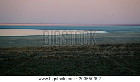 Panorama view to Aral sea from the rim of Plateau Ustyurt near Aktumsuk cape at sunset in Karakalpakstan, Uzbekistan