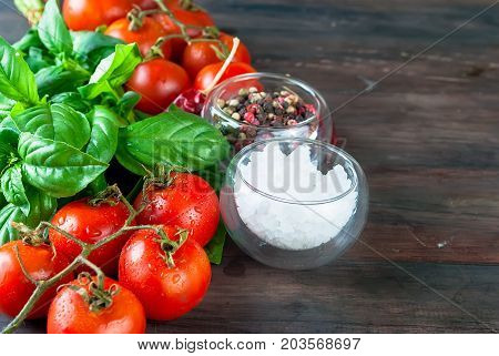 Tomatoes And Bunch Of Fresh Green Basil On A Dark Wood Background,