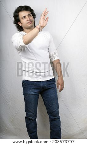 indian male model in white tshirt saying hellow