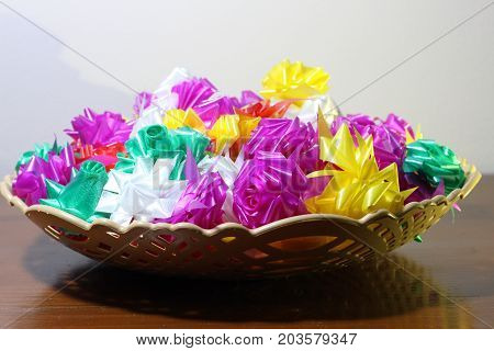 colorful ribbonsSet ribbon folded into a flower. Wrap coins by hand. for the sacred(ordination ,matriculation ,initiation) in Thailand
