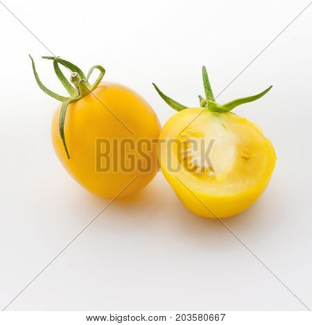 Fresh yellow tomatoes close up isolated on white background. Top view