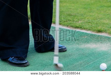 Golf Player At Tee Off On A Golf Course