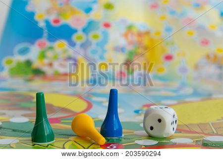 Blue yellow and green plastic chips dice and Board games for children .