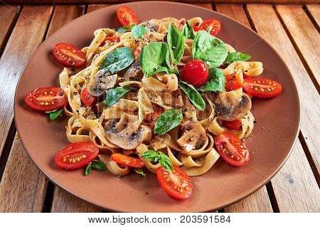 Home Made Vegan Pasta With Mushrooms, Tomatoes, Basil, Peppers And Aubergines - Served On Plate At W