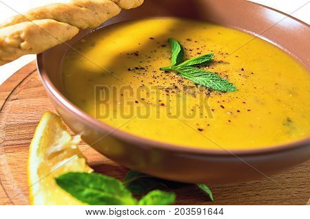 Turkish Traditional Lentil Cream Soup With Mint, Lemon And Homemade Bread. Ezogelin.