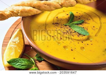 Turkish Traditional Lentil Cream Soup With Mint, Lemon And Homemade Bread. Ezogelin.