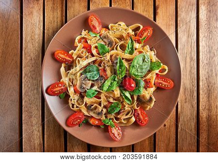 Home Made Vegan Pasta With Mushrooms, Tomatoes, Basil, Peppers And Aubergines - Served On Plate At W