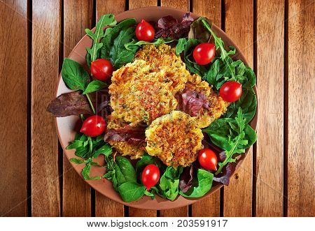 Homemade Veg Burgers From Potatoes And Lentils, Served On A Plate With Tomatoes And Green Salad On A