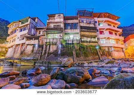 Old riverside architecture in the Shiding district at night