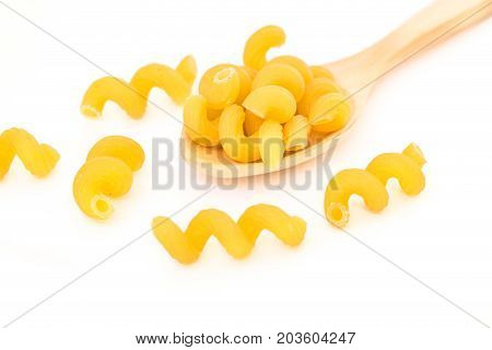 Raw Italian Macaroni Pasta on wooden spoon.