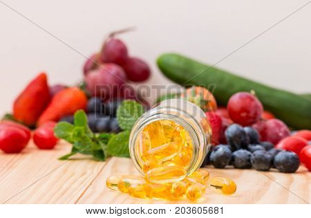 Fish oil omega 3 with vitamin D capsules good for heart health on a white backguound healthy diet concept