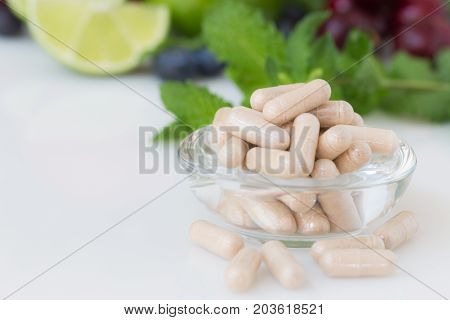 Vitamins supplements in bottle on marble table.