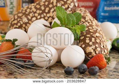 Eggs bread and ingredients prepare for cooking on marble table.