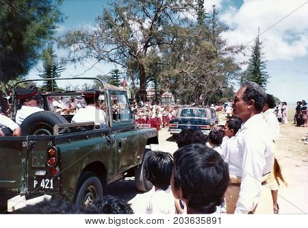 NUKU'ALOFA, TONGATAPU / TONGA - CIRCA 1990: A military jeep follows a luxury Mercedes-Benz car, carrying King Taufa'ahau Tupou IV, during a holiday in Tonga's capital city.
