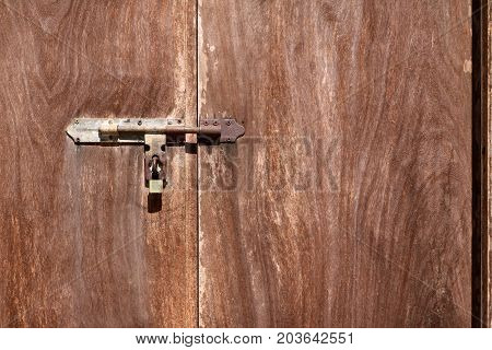 The old wooden door with latchkey in the temple Thailand.