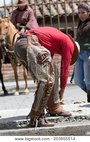 June 10 2017 Toacazo Ecuador: man arranging his chaps before rodeo