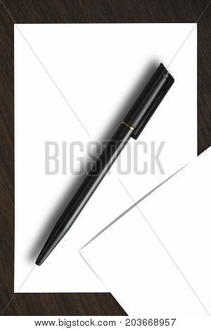 Blank paper with black pen. White paper and black pen on wooden table.