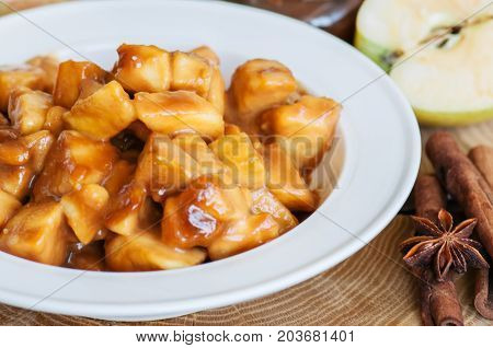 Aplle Pie Filling In A White Plate On A Wooden Background. Traditional American Baking