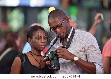 NEW YORK CITY USA - AUG. 26 : Unidentified people on the Times Square in Manhattan on August 26 2017 in New York City NY. Times Square is a major commercial intersection tourist destination and entertainment center in NYC.