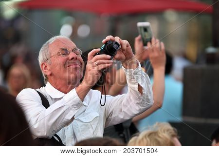 NEW YORK CITY USA - AUG. 26 : Unidentified people on the Times Square in Manhattan on August 26 2017 in New York City NY. Times Square is a major commercial intersection tourist destination and entertainment center in NYC.