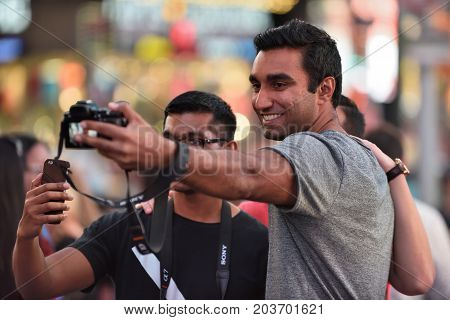 NEW YORK CITY USA - AUG. 26 : Unidentified people on the Times Square in Manhattan on August 26 2017 in New York City NY. Times Square is a major commercial intersection tourist destination and entertainment center in NYC.