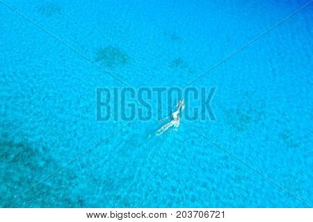 Birds eye view of jet ski riding at blue tropical ocean.